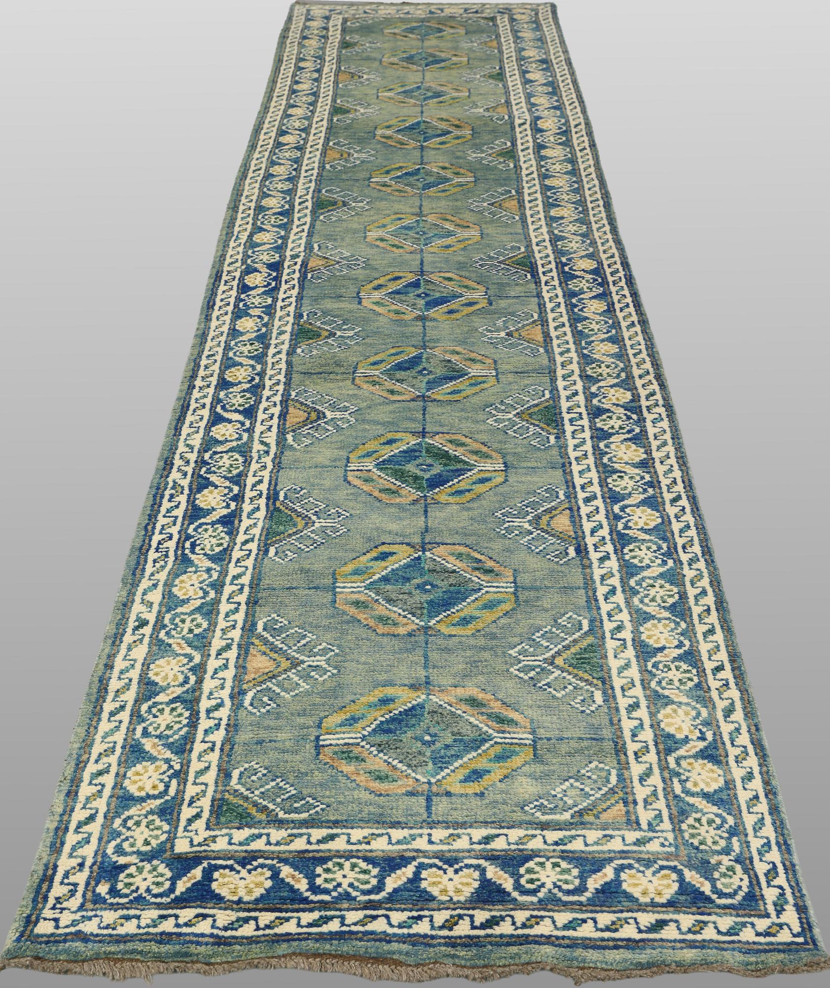 An Oriental runner, c. 393 x 79 cm.