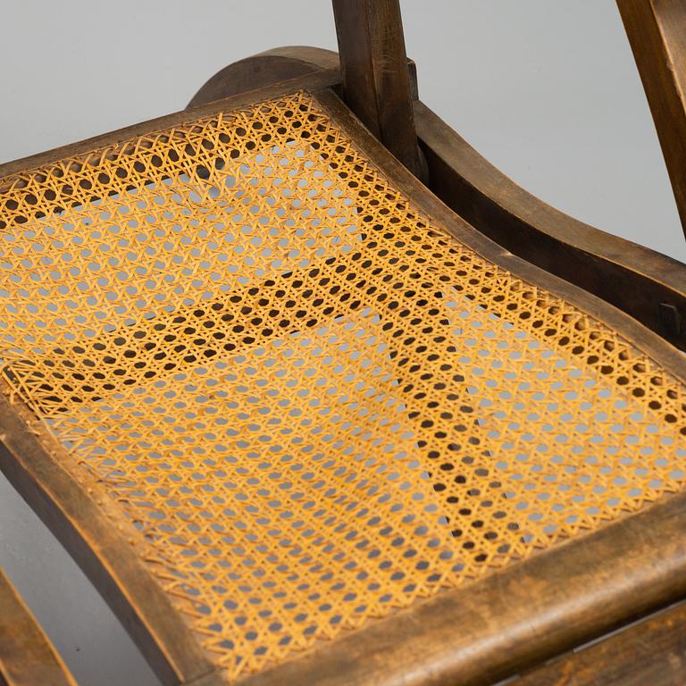 A stained wood and rattan deck chair, first half of 20th century.