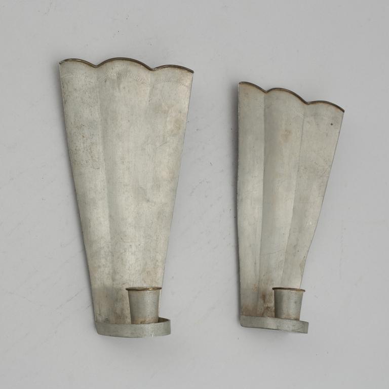 Firma Svenskt Tenn, a pair of pewter and brass wall sconces, Sweden 1925.