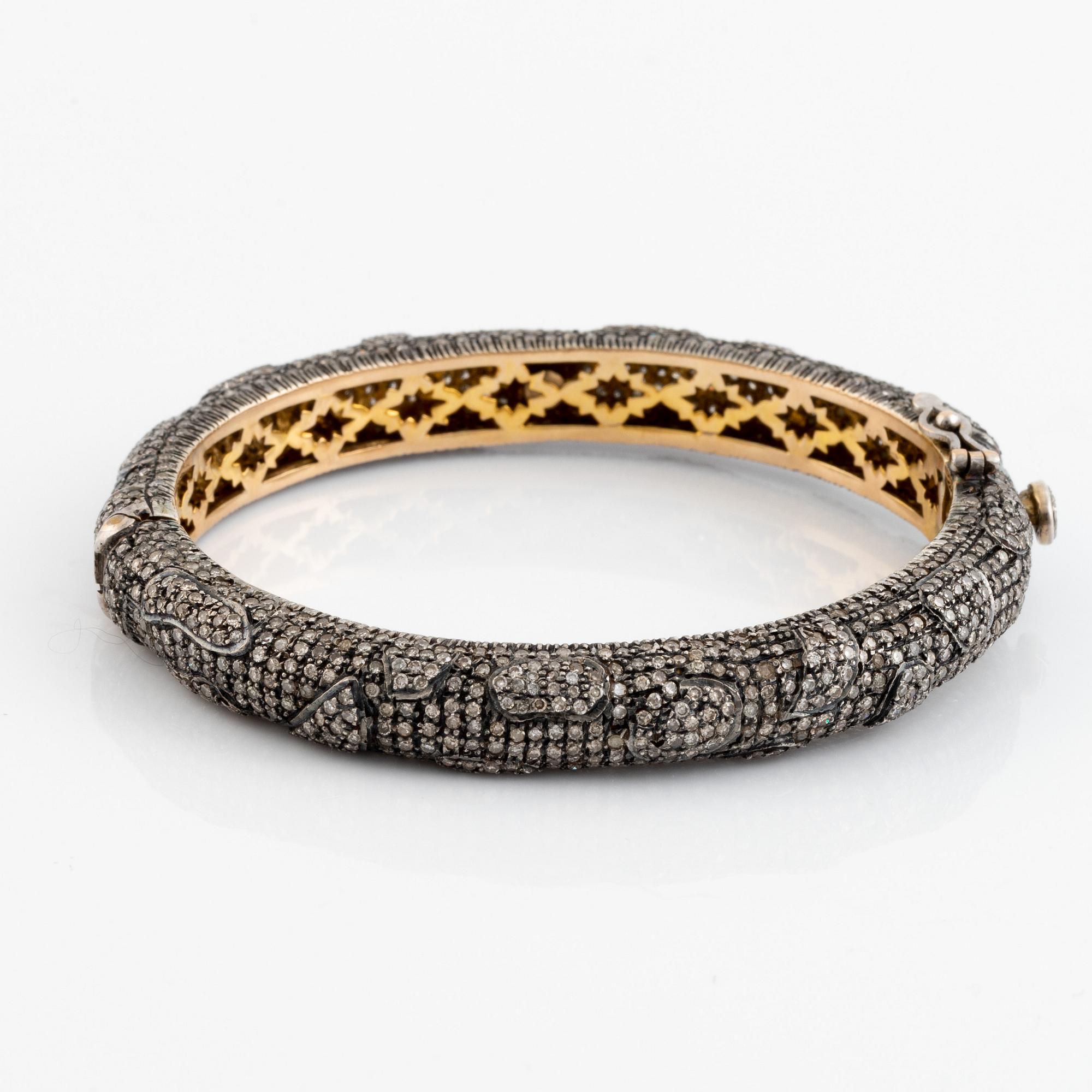 Silver and giltet gold and eight cut diamond bangle.