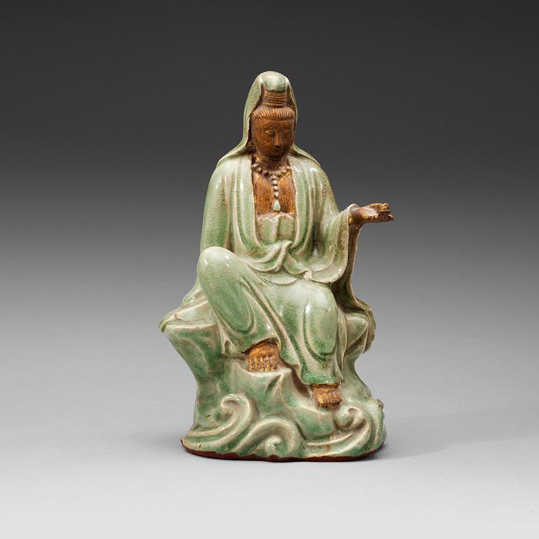 A seated celadon figure of Guanyin, presumably Longquan Ming dynasty, 17th Century.