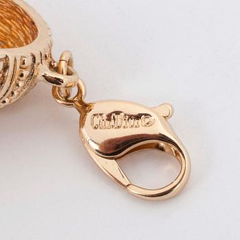 CHRISTIAN DIOR, a gold colored metall braclet with decorative glass stones.