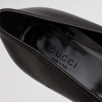 GUCCI, a pair of black leather pumps.