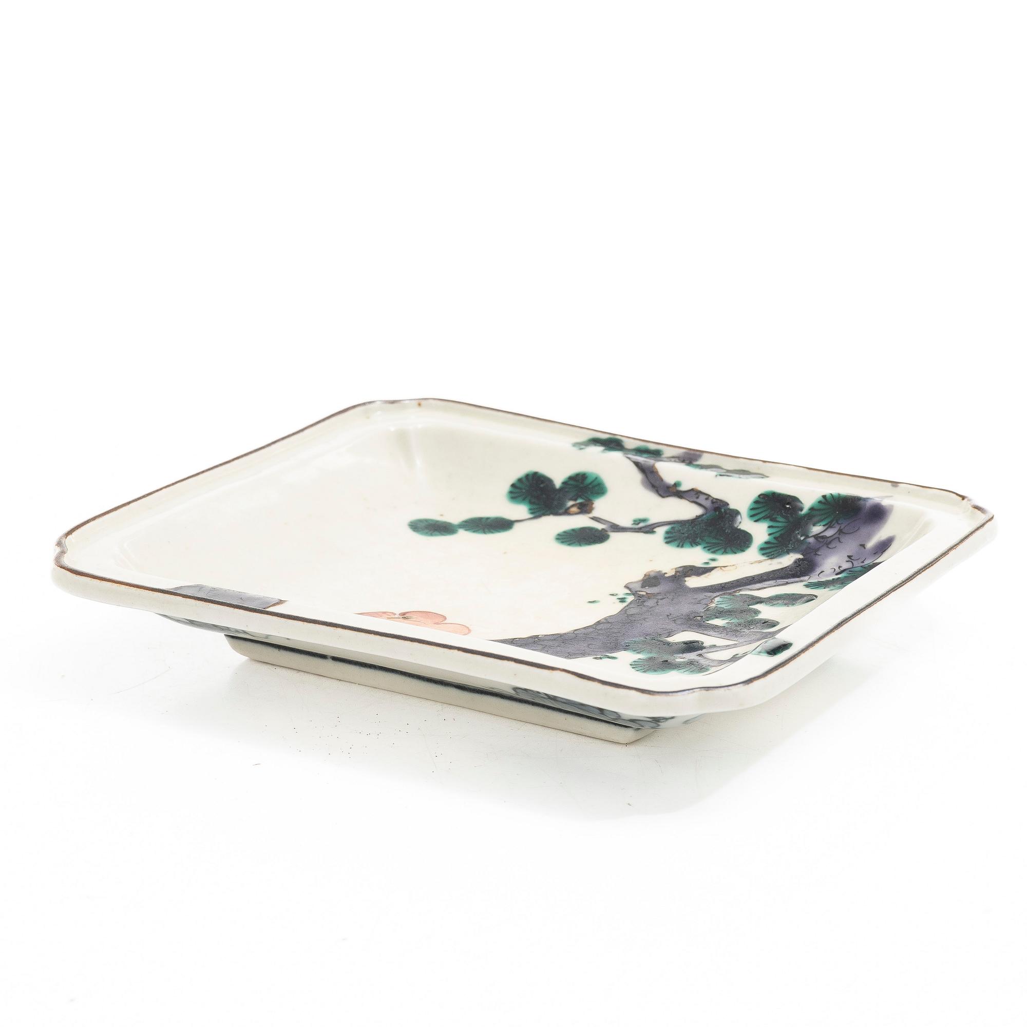 A small Japanese gilt copper box with cover and a porcelain dish, 19th century.