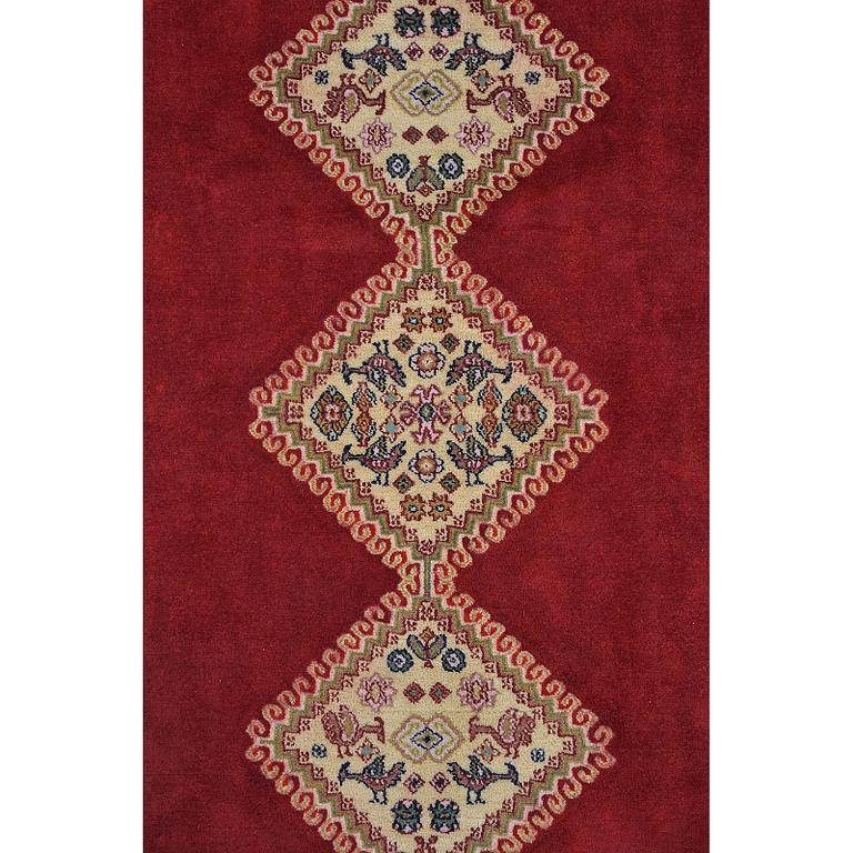 A Persian Rug, approximately 240 x 165 cm.