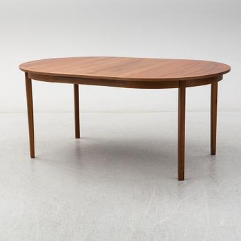 A second half of the 20th Century walnut veneered dinner table.