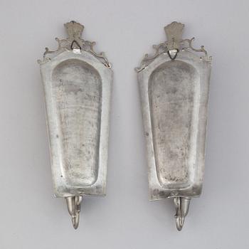 A pair of 20th century pewter wall sconces for ine candle.