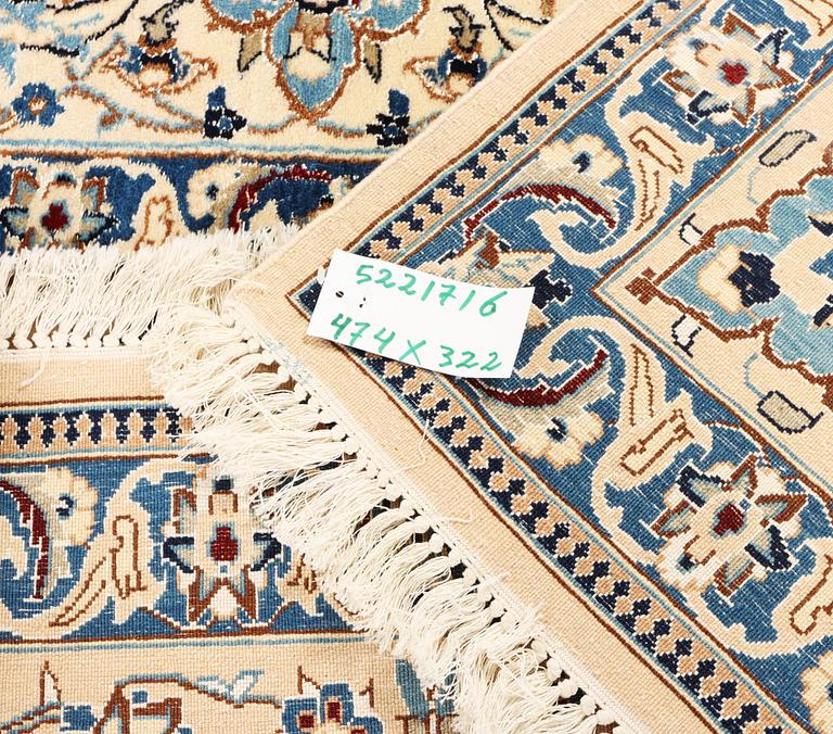 A Nain, part silk carpet, c. 474 x 322 cm.