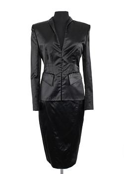 A two-piece black silk costume consisting of jacket and skirt by Gucci.