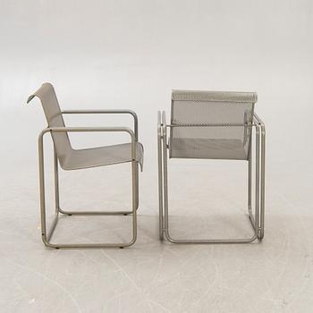 A pair of metal 1970/80s armchairs.