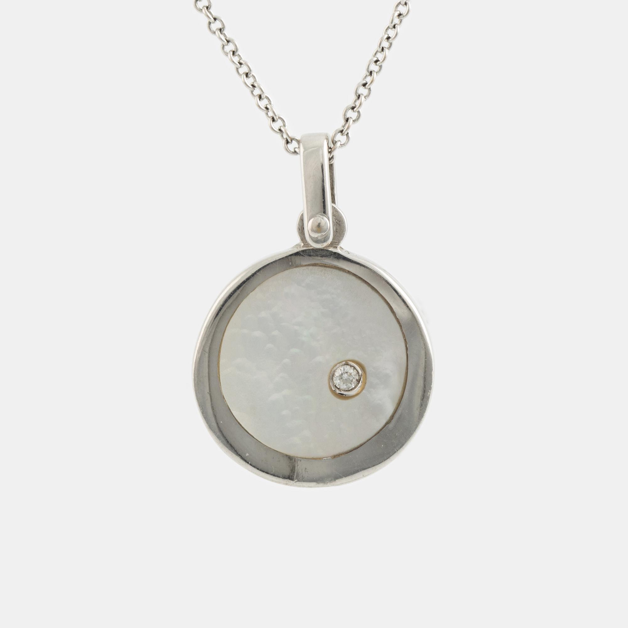 White gold, mother of pearl and round brilliant cut diamond necklace.