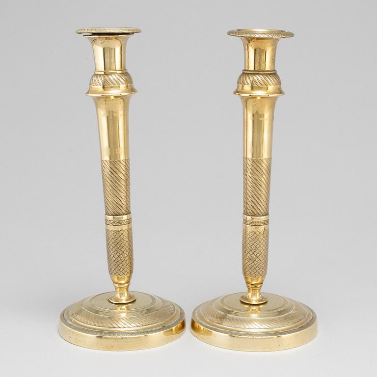 A mid 19th Century pair of brass candle sticks.