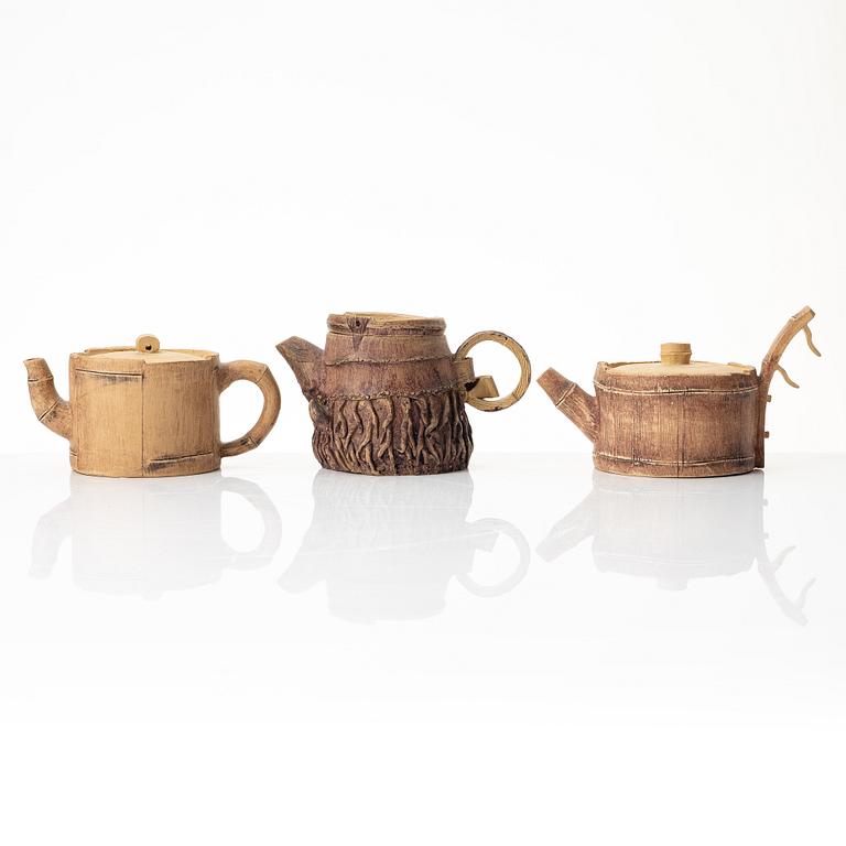 A group of three bright yellow yixing 'Gongfu' teapots, China, 1990s.