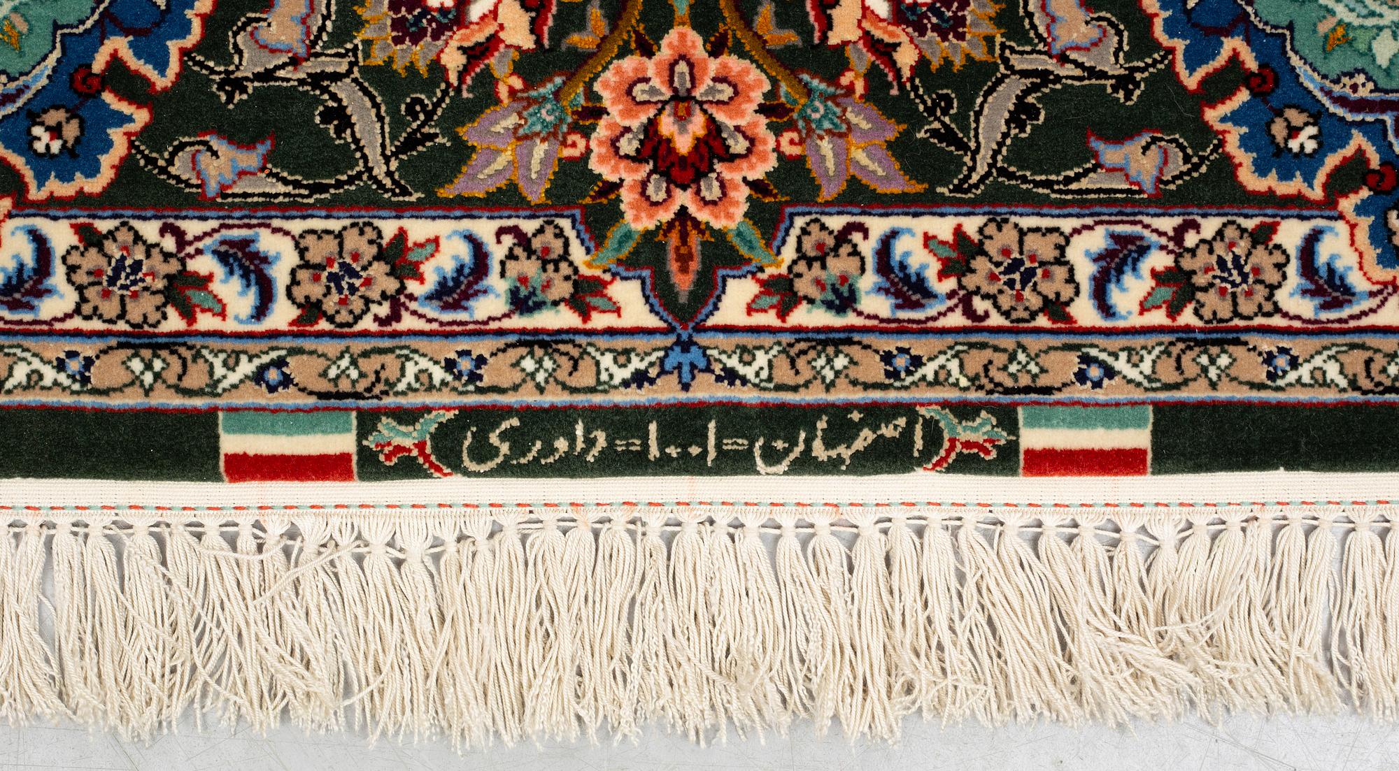 A rug, old Esfahan, part silk, signed, ca 225 x 149 cm (ca 1,5-2,5 cm flat weave at the ends).
