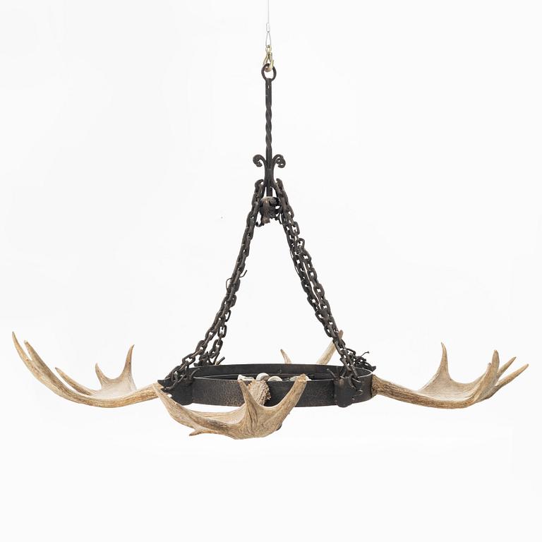 A moose horn and cast iron chandelier from around 1900.