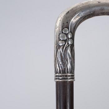 A CANE WITH SILVER MOUNTING, 1910.