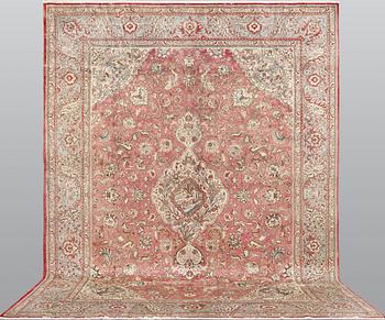 A Tabriz carpet, signed, c. 395 x 298 cm.