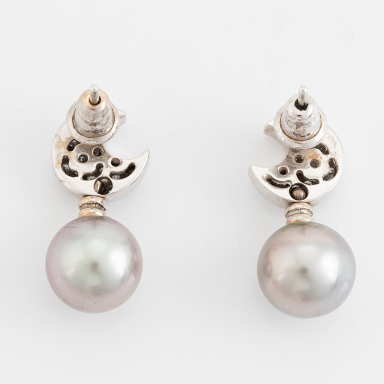 Brilliant cut diamond moon shape and cultured grey pearl earrings.
