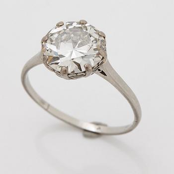 A platinum ring set with a round brilliant-cut diamond weight ca 4.90 cts quality ca W si.