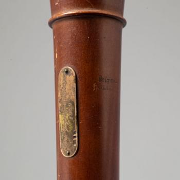 A brass shelf and two flutes, 20th century.