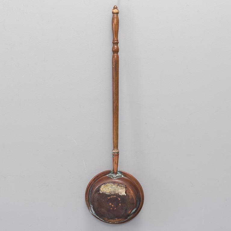 A 18th century copper bed warmer.