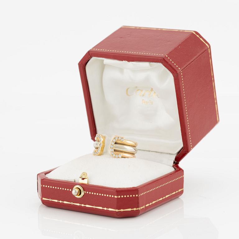 Cartier "Double C" ring in 18K tri-colour gold with round brilliant-cut diamonds.