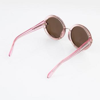 Karen Walker, a pair of pink "Orbit" sunglasses.