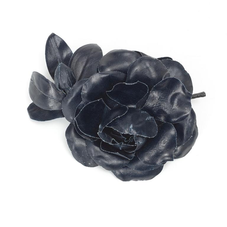 YVES SAINT LAURENT, a dark blue brooch.