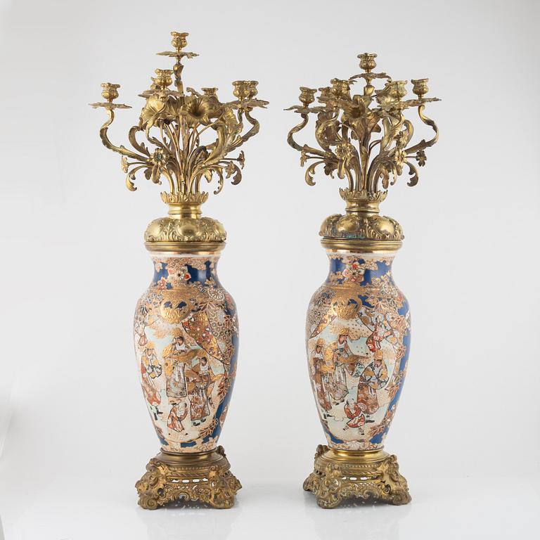 A pair of gilt-brass and satsuma ware seven-light candelabra, the porcelain Meiji period (1868-1912).