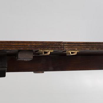 An english style dining table and eight chairs, second half of the 20th century.