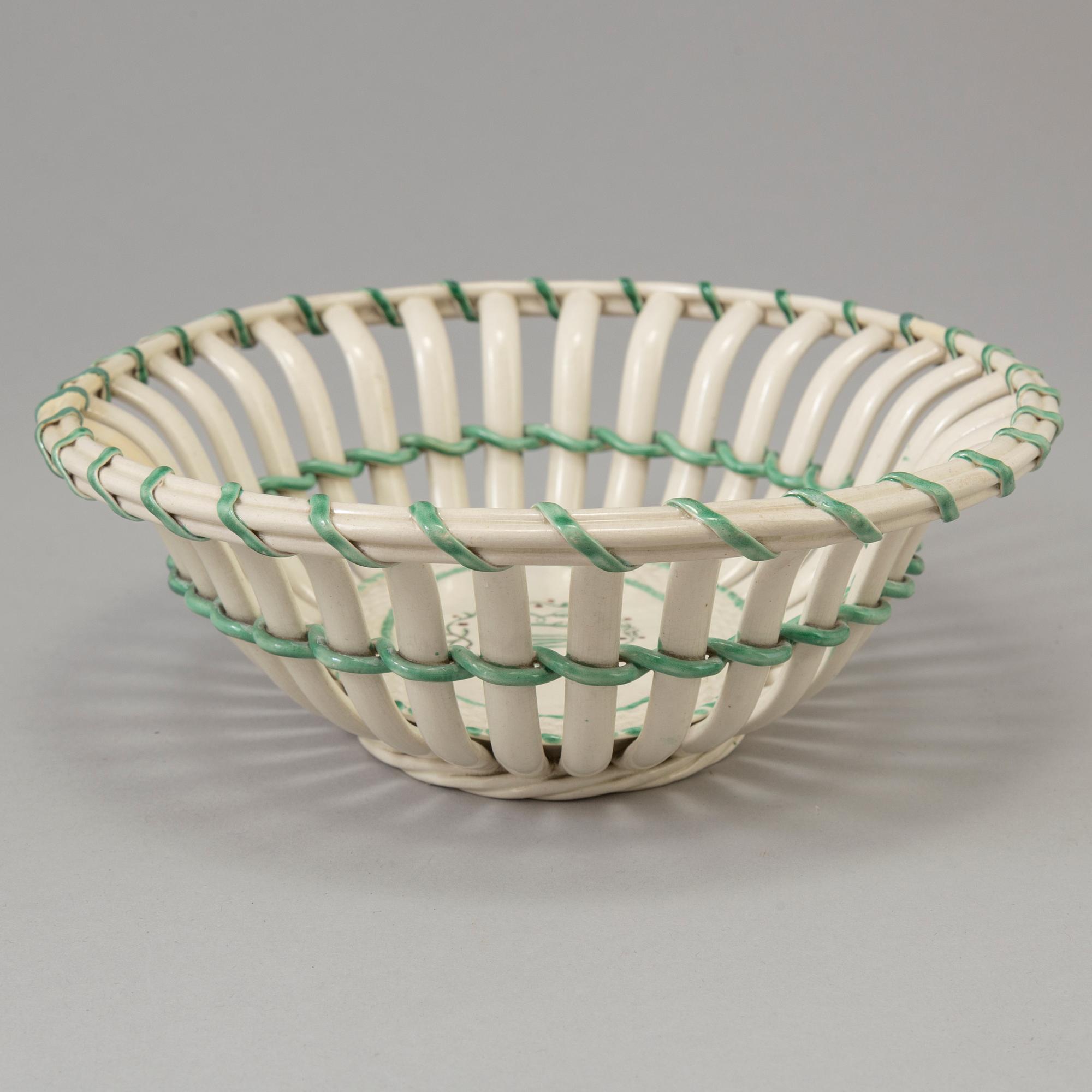A CREAMWARE BASKET, PLATE AND A SIMILAR PLATE, one marked Wedgwood, first half of the 19th century.