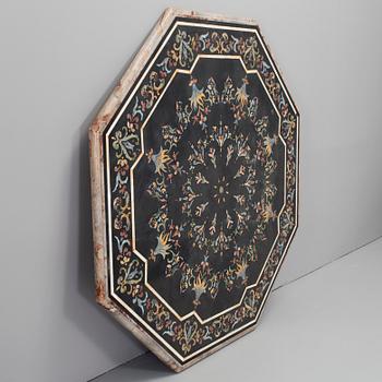 An oktagonal stone table top with inlays, Italy, about 1900.