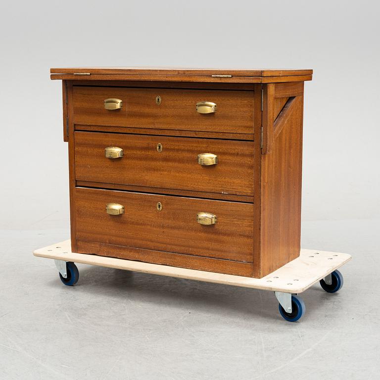 A mahogany veneered chest of drawers with tilt-top, first part of the 20th Century.