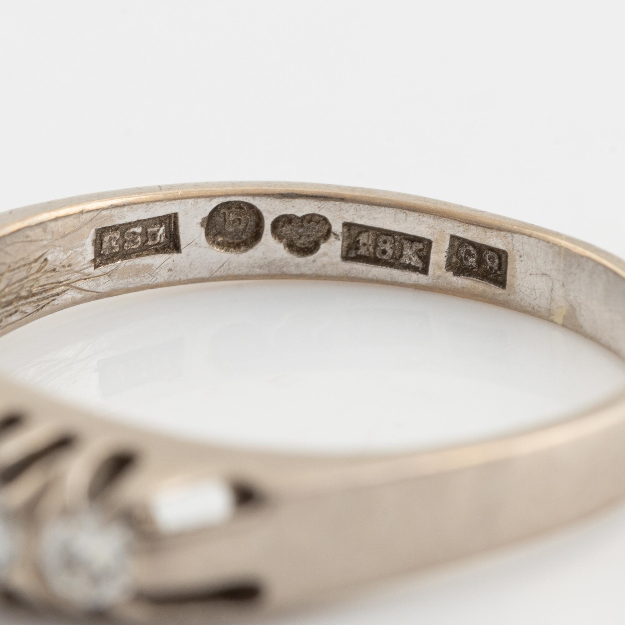 An 18K white gold ring set with round brilliant-cut diamonds.