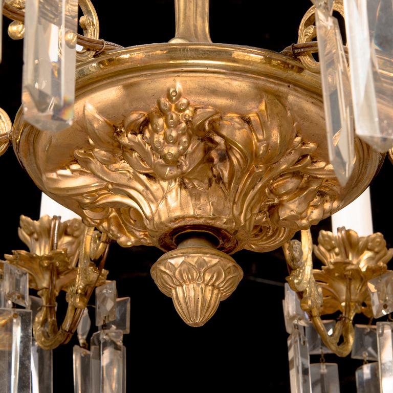 A brass chandelier with prisms, late 19th century. Height 75 cm.