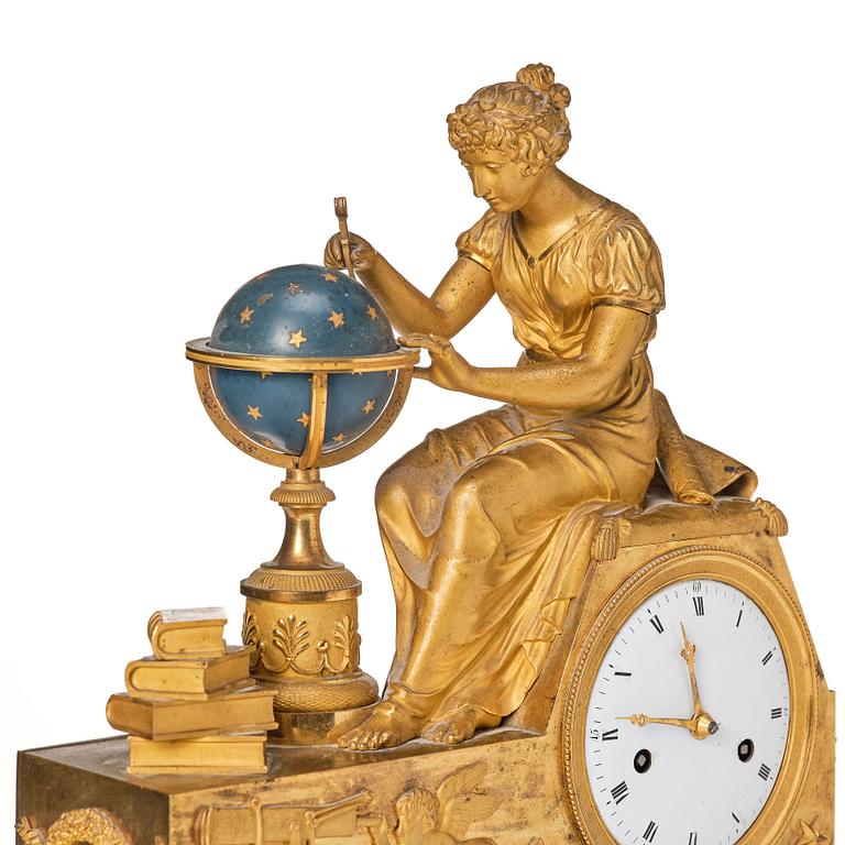 A patinated, ormolu, and marble French Empire figural mantel clock, early 19th century.