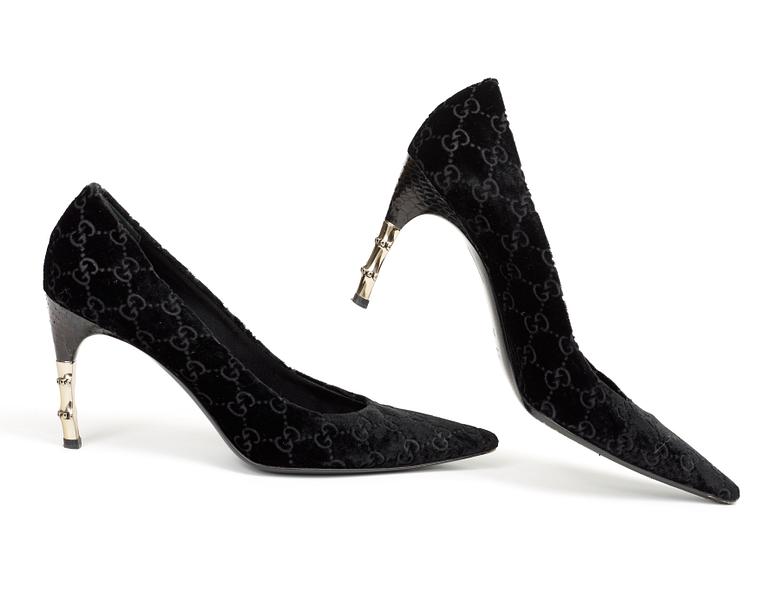 A pair of lady shoes by Gucci.