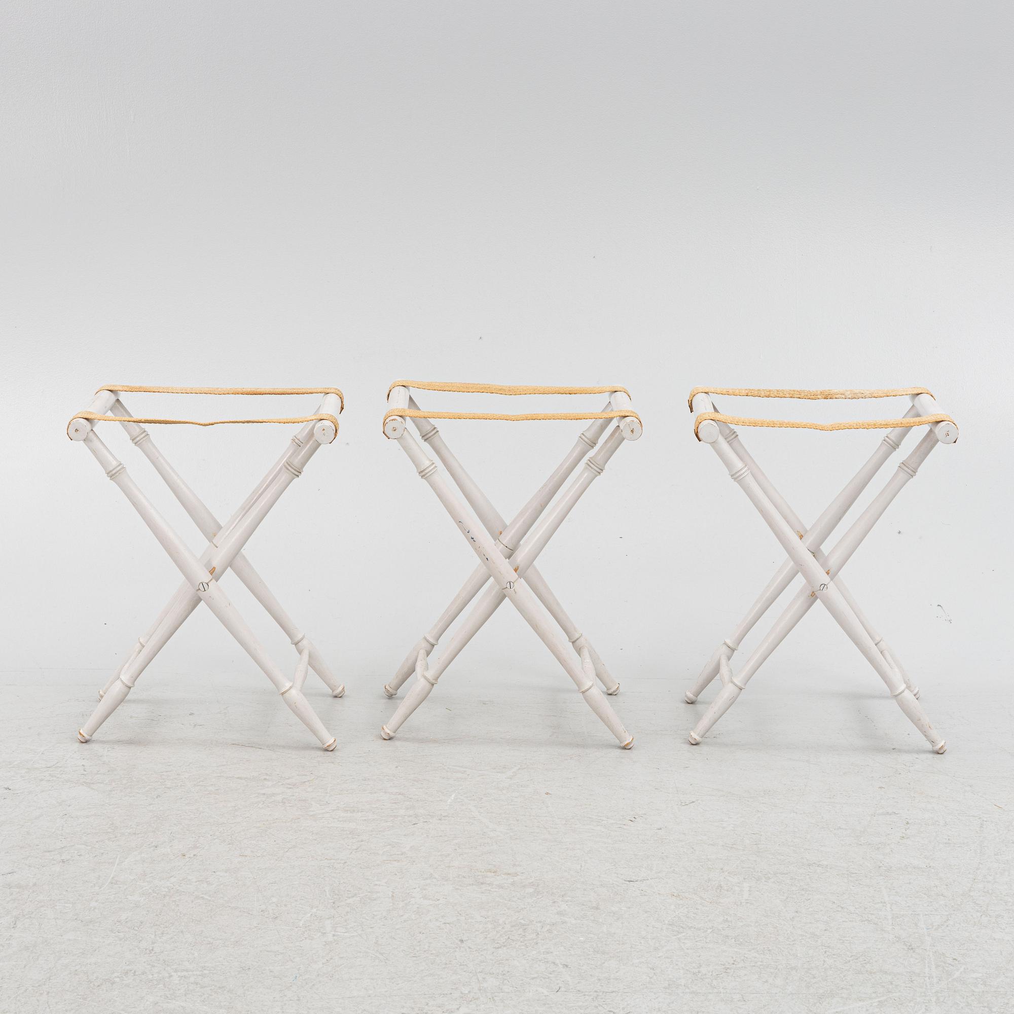 A set of three luggage stands, 20th century.
