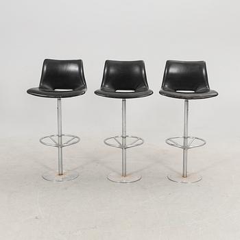A set of three late 20th century metal and leather bar stools.