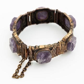 Pentti Sarpaneva, A bracelet, a pair of earrings, a ring, and a pendant, bronze with amethyst, Finland 1960s.