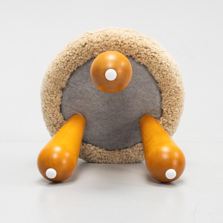 A contemporary stool with birch legs and new sheepskin upholstery.