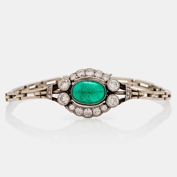 A cabochon cut emerald and brilliant cut diamond bracelet. Total carat weight of diamonds circa 1.10 cts.