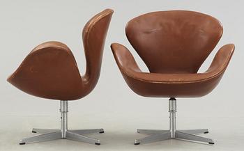 A pair of Arne Jacobsen brown leather 'Swan' chairs, Fritz Hansen, Denmark 1972.