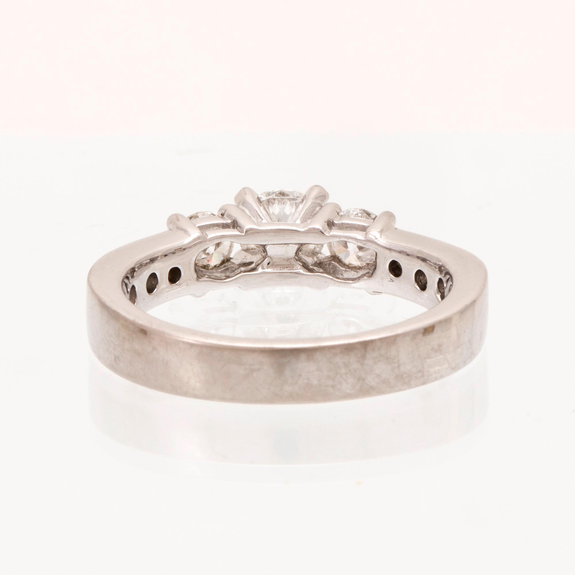 An 18K white gold ring set with round brilliant cut diamonds.