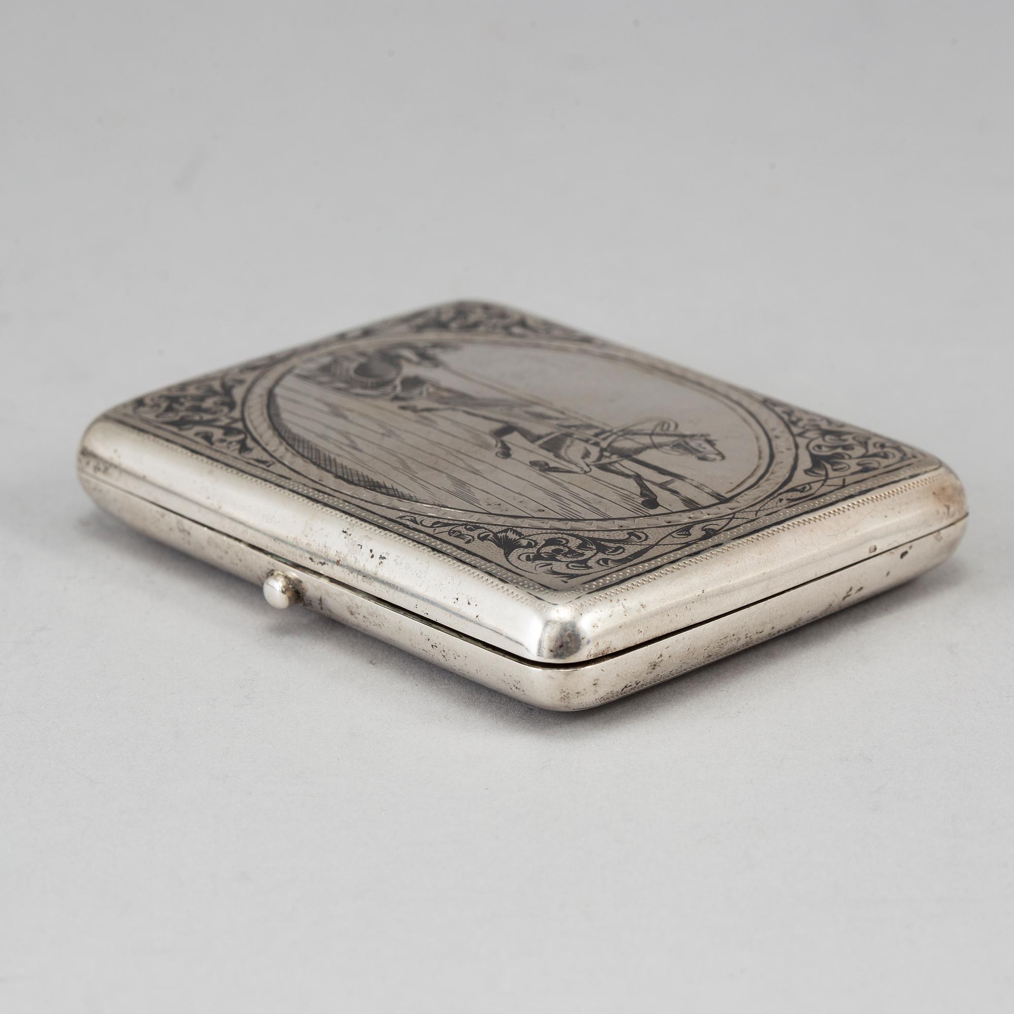 A Russian parcel-gilt silver and niello cigarette-case, import marks 1882-98.