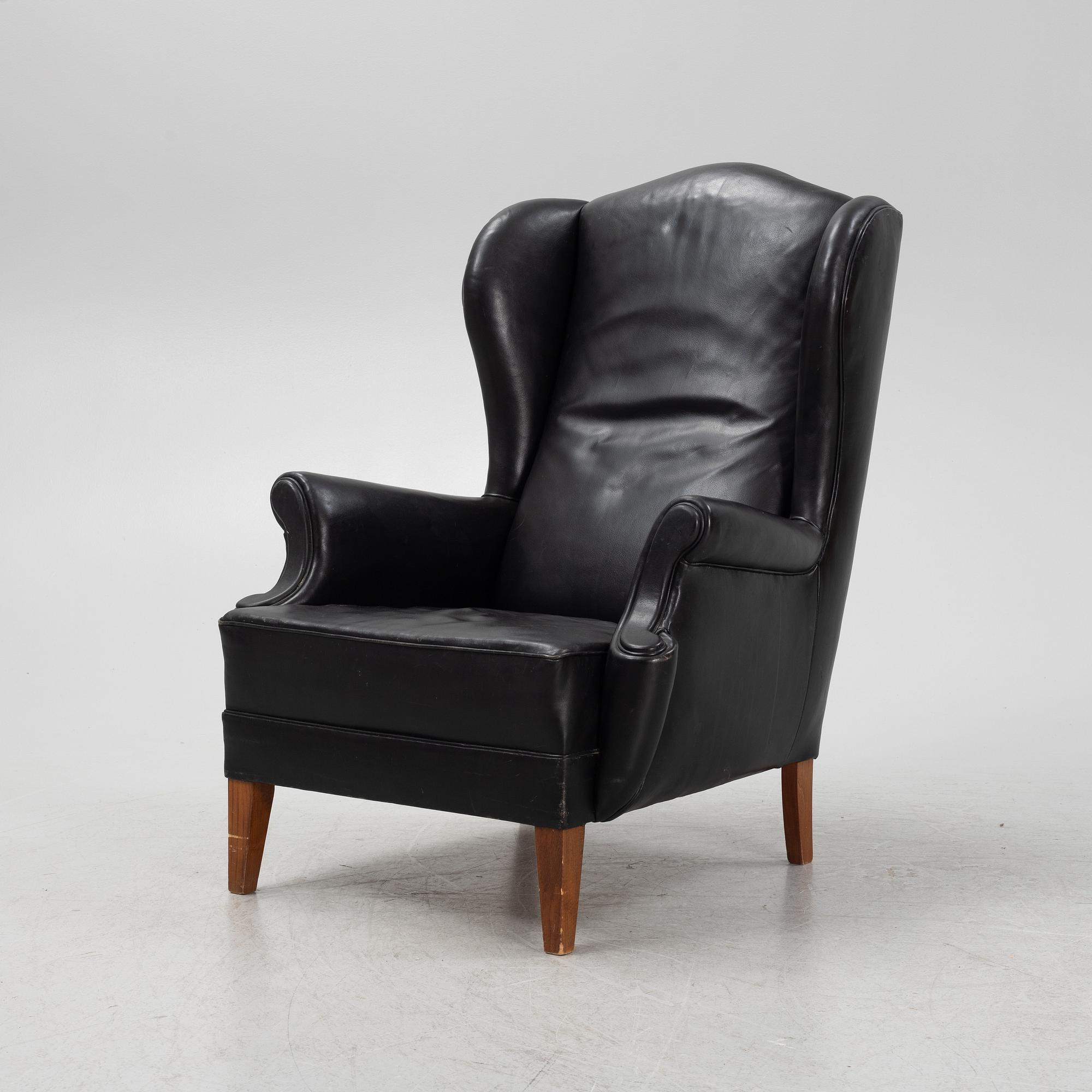 A leather upholstered wingback chair, 20th Century.