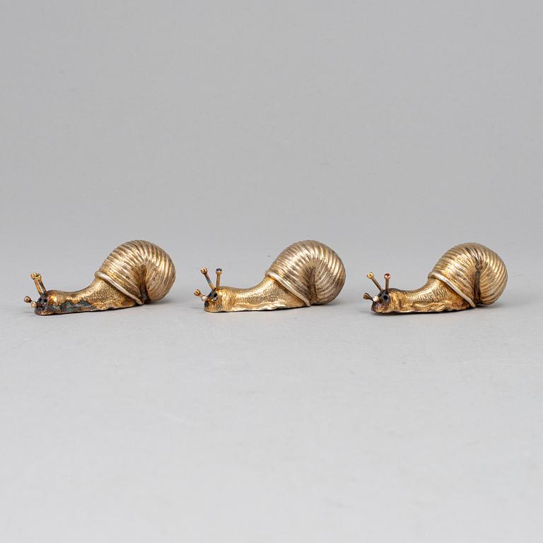 A set of three silver gilt salt-cellars, unmarked.