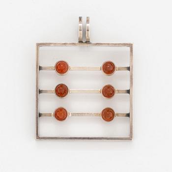 A silver pendant set with carnelian.