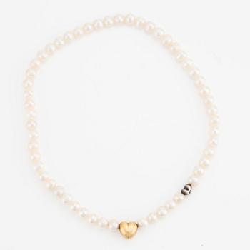 Ole Lynggaard 18K gold clasp in the shape of a heart with a cultured freshwater pearl necklace with a silver heart.