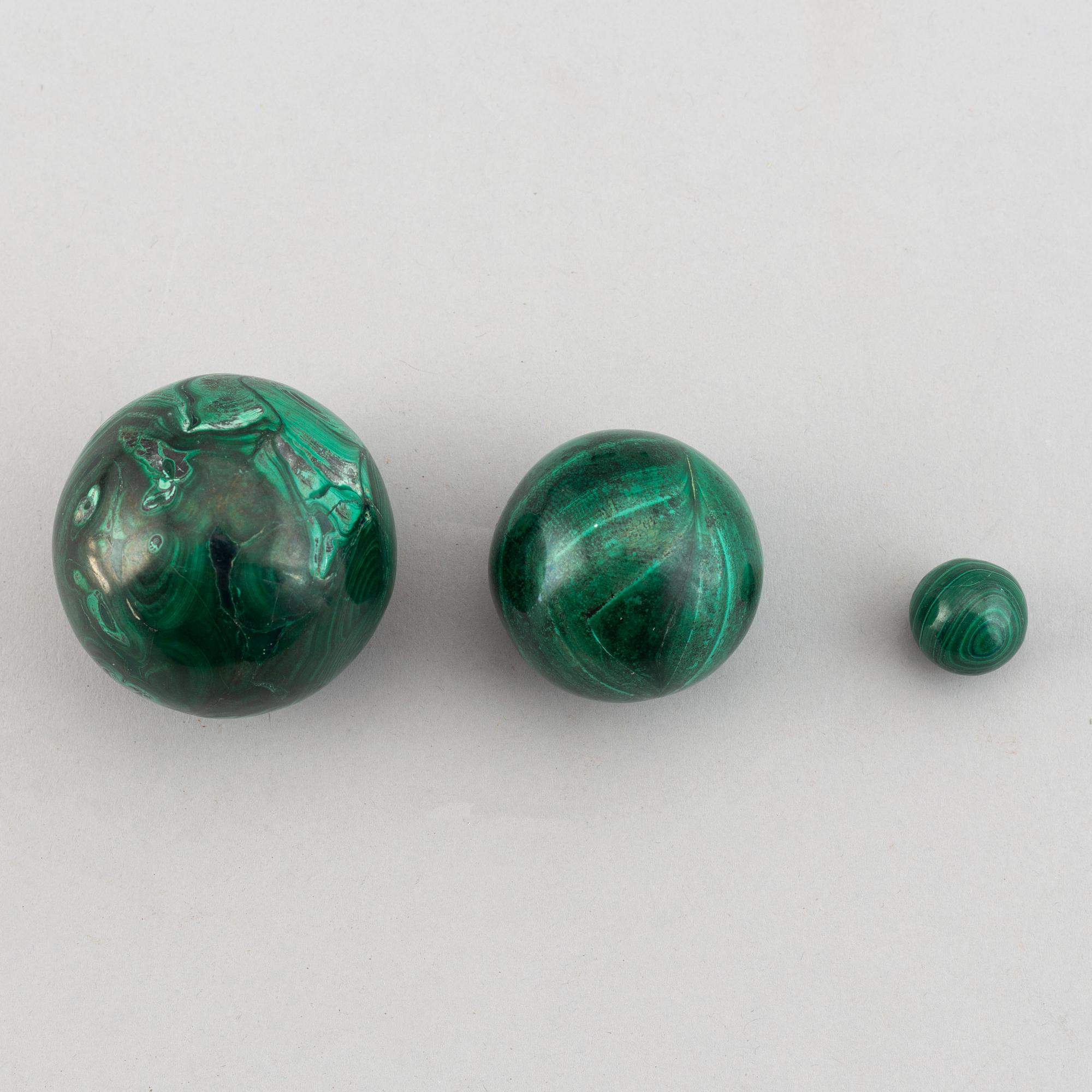 Six 20th century malachite balls and an egg.